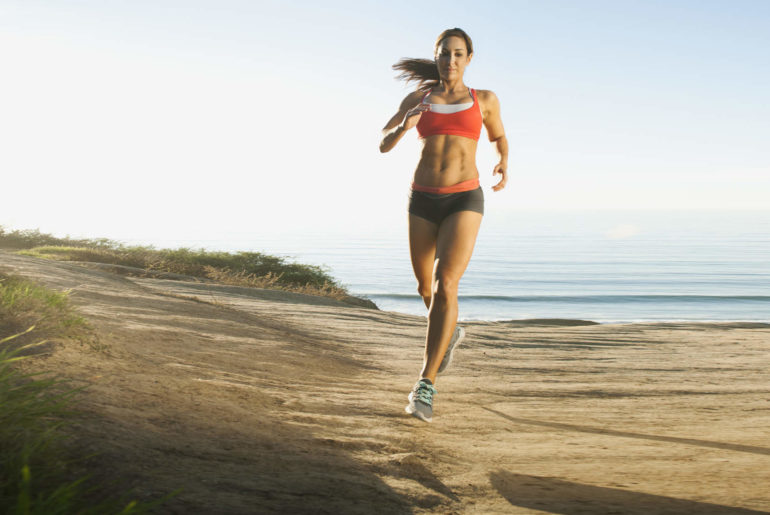 USA,-California,-San-Diego,-Woman-training-on-coast